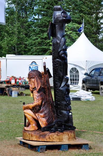 man and totem carving